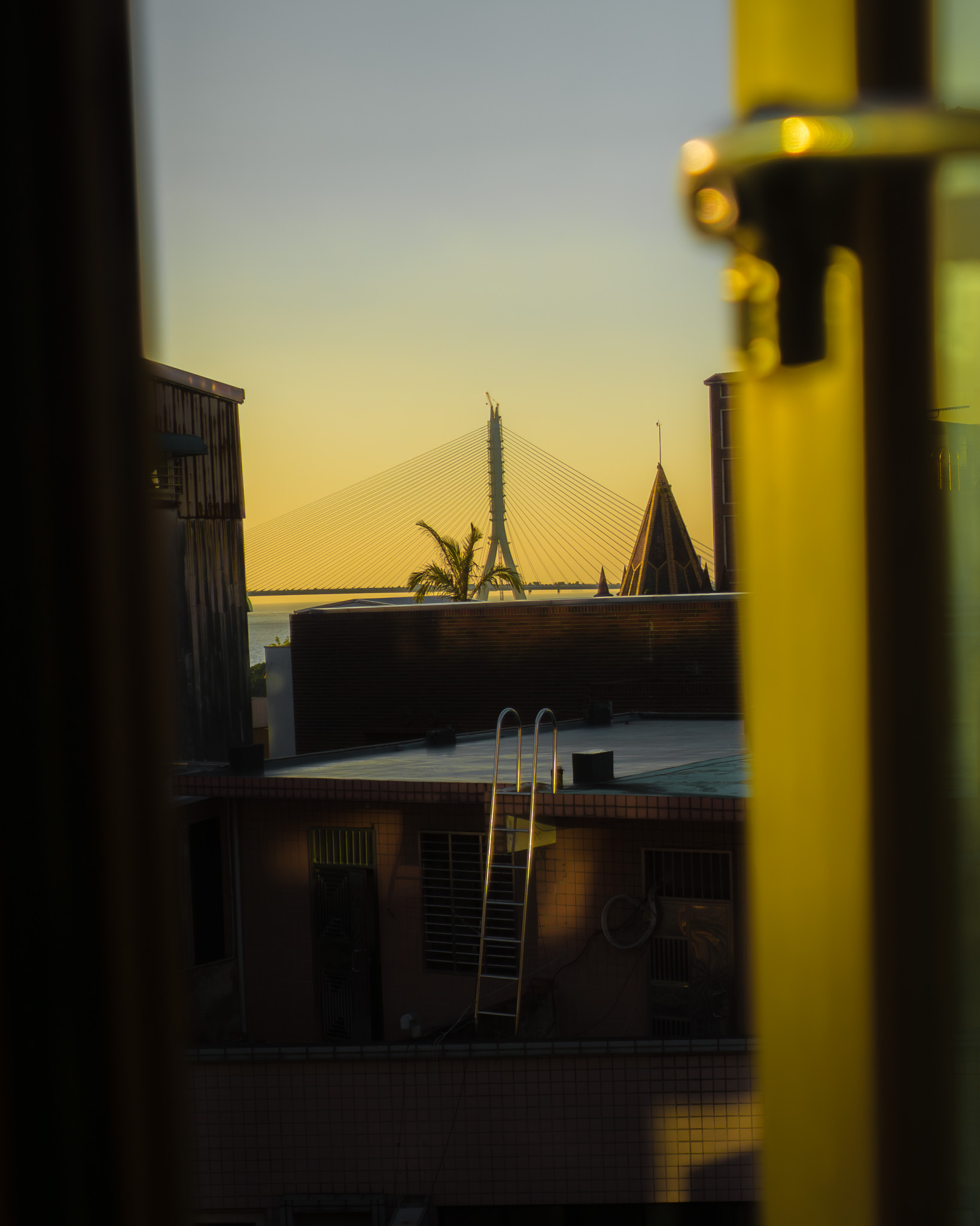 Tamsui bridge seen through a window at sunset